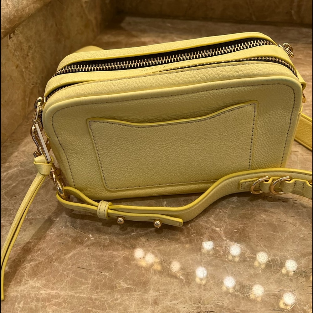 Small, yellow crossbody Marc Jacob’s bag. 8inches long,5 inches in height.